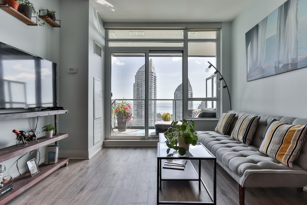 white and black striped sofa near glass window