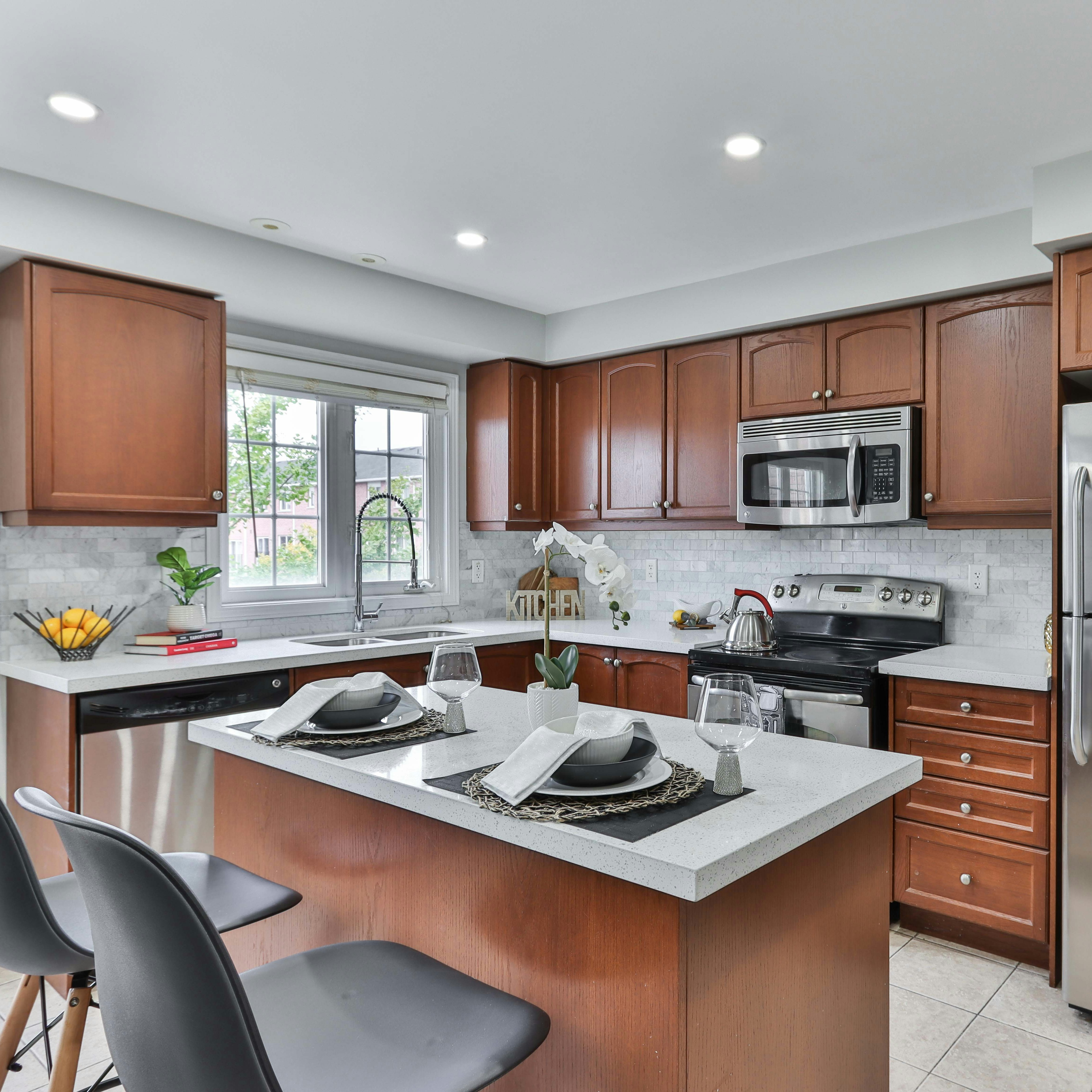 silver top mount refrigerator beside brown wooden kitchen cabinet