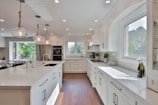 white wooden kitchen cabinet with kitchen sink