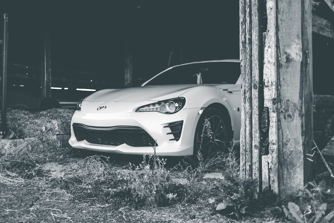 grayscale photo of white porsche 911