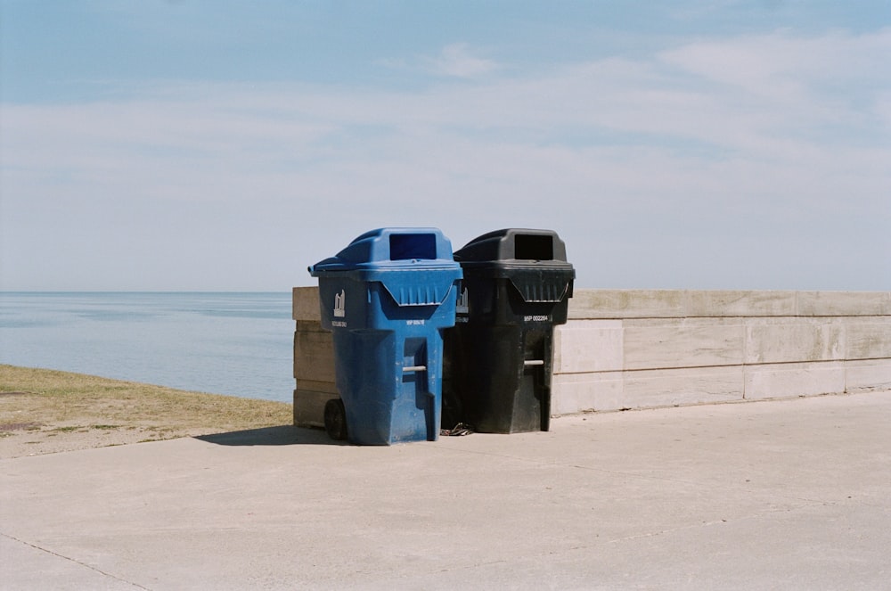 blue trash bin on beach during daytime