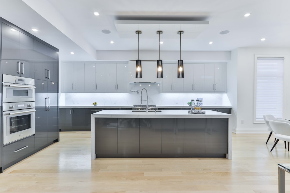 Modern kitchen interior with fitted oven, microwave and refrigerator. Stock  Photo