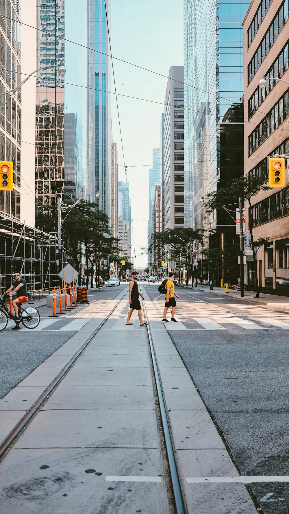 people walking on sidewalk near city buildings during daytime