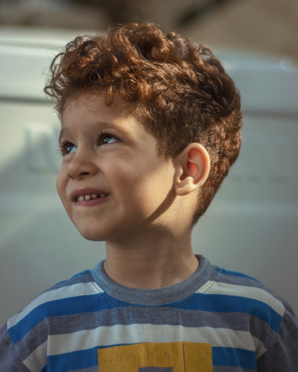 boy in blue and white striped crew neck shirt