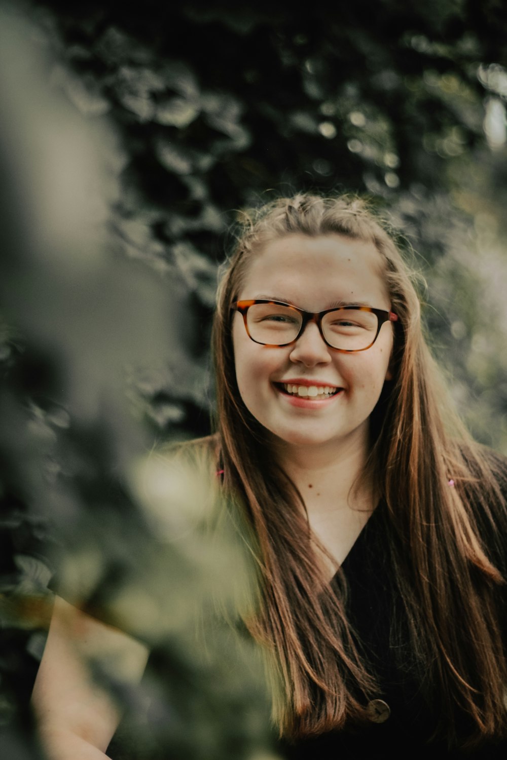 woman in black shirt wearing eyeglasses