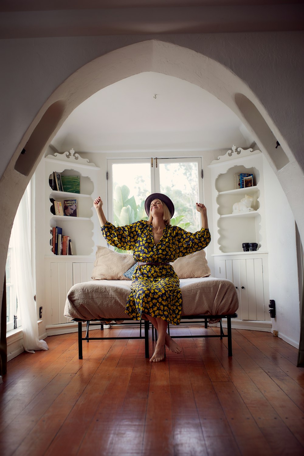 woman in brown and black floral dress sitting on brown wooden chair