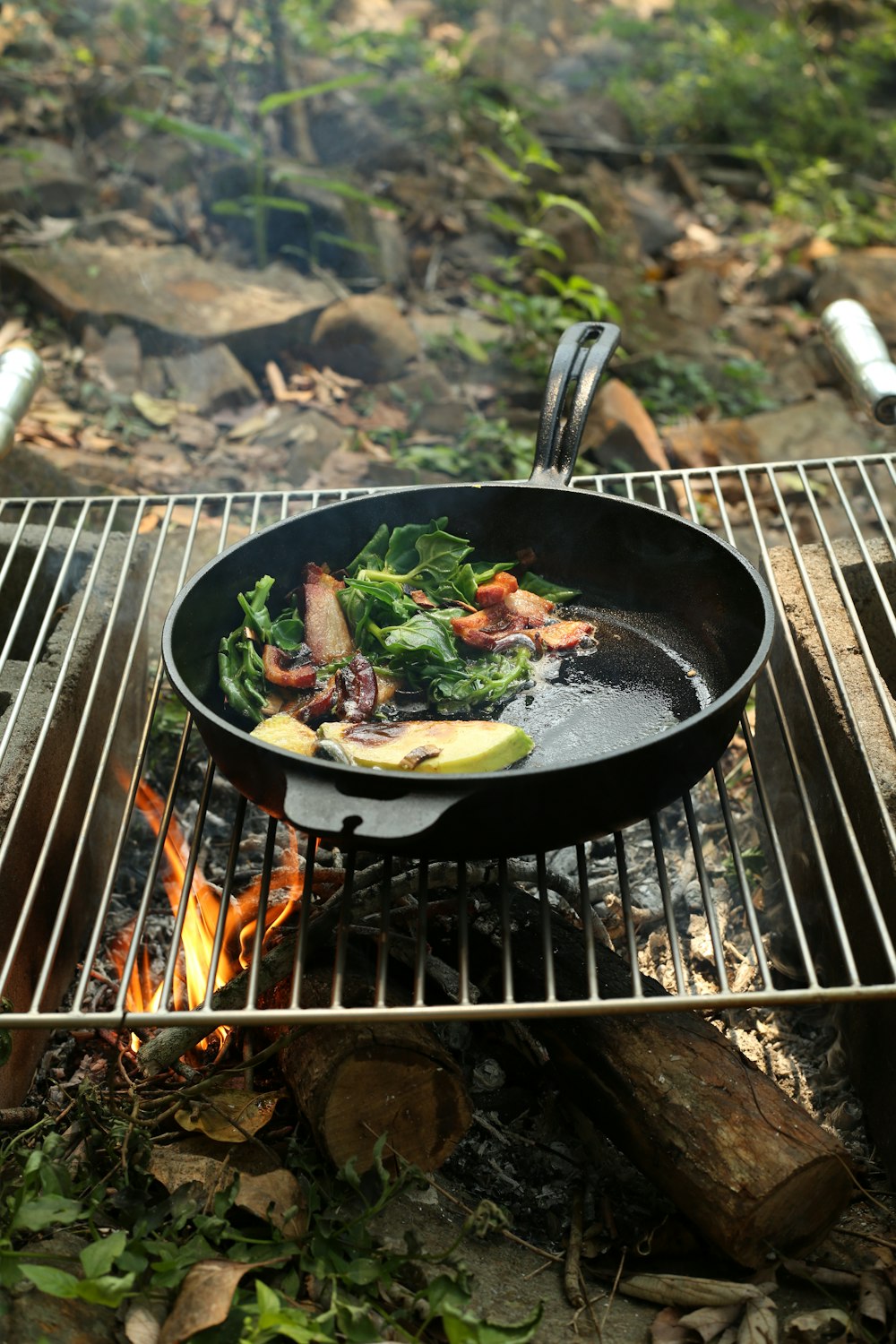 black cast iron pan on charcoal grill