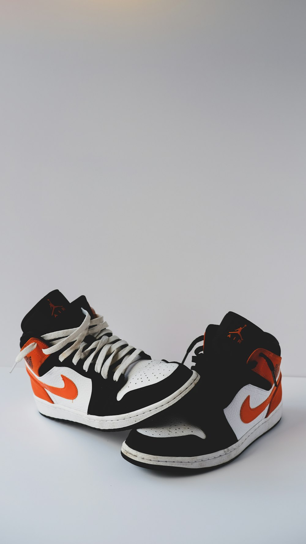 black white and red nike high top sneakers