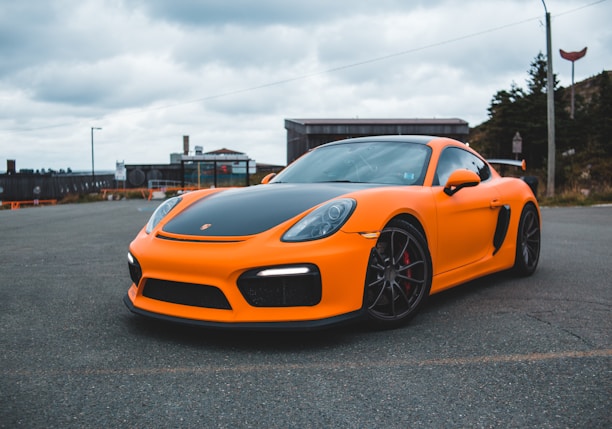 orange lamborghini aventador parked on gray asphalt road during daytime