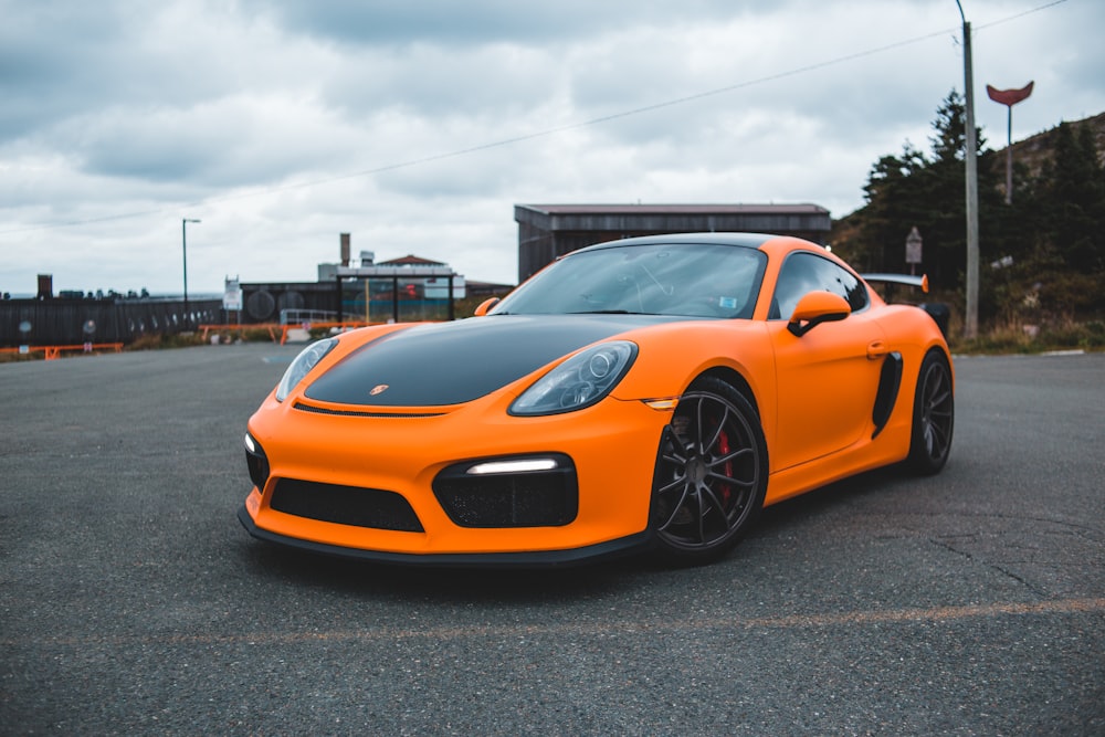 orange lamborghini aventador parked on gray asphalt road during daytime