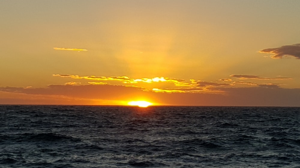 body of water during sunset