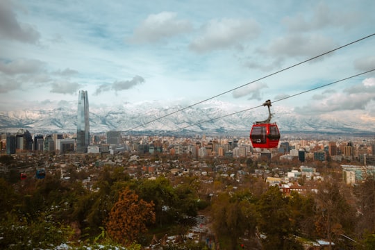 red cable car over bridge in Santiago Chile