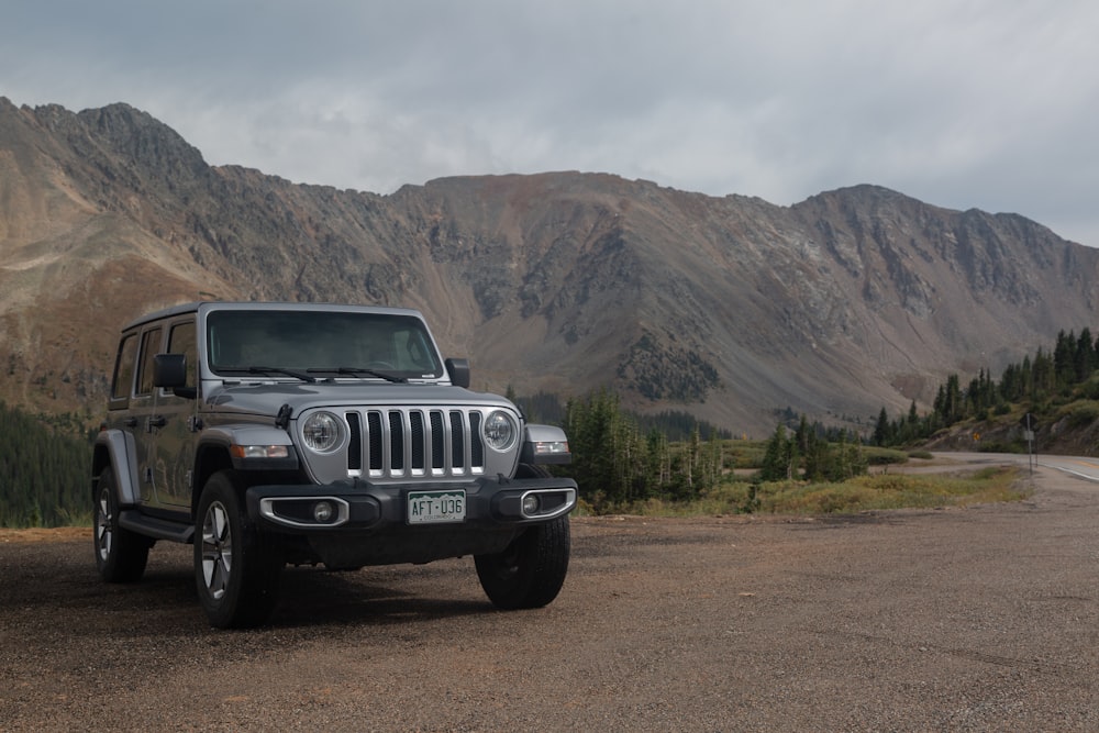 white jeep wrangler on green grass field under white clouds during daytime  photo – Free Brown Image on Unsplash