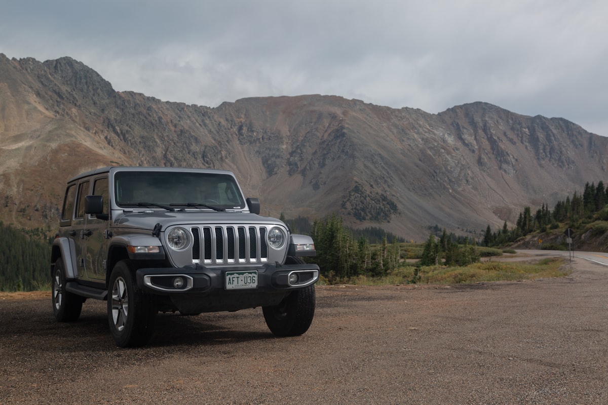Black Jeep Wrangler on dirt road in desert off-road terrain