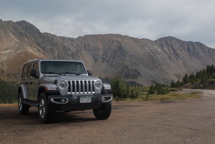 Black Jeep Wrangler on desert dirt road