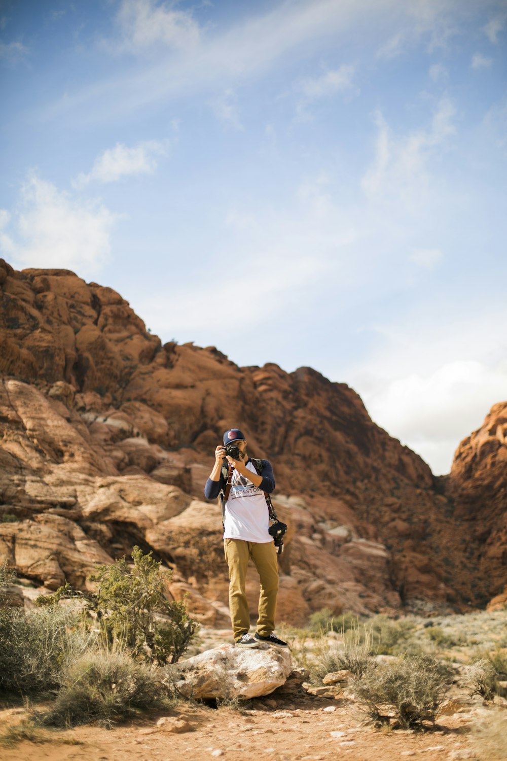 man and woman standing on brown rock formation during daytime