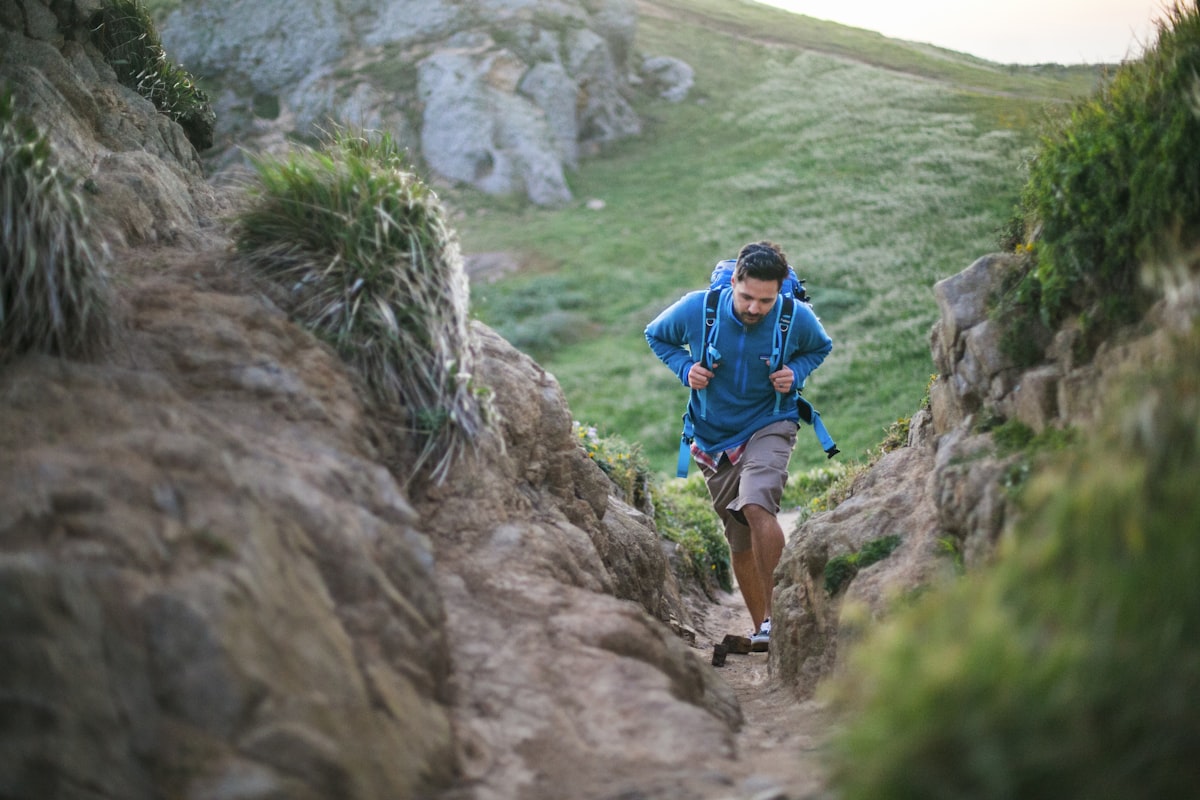 Runner ascending a rocky mountain path