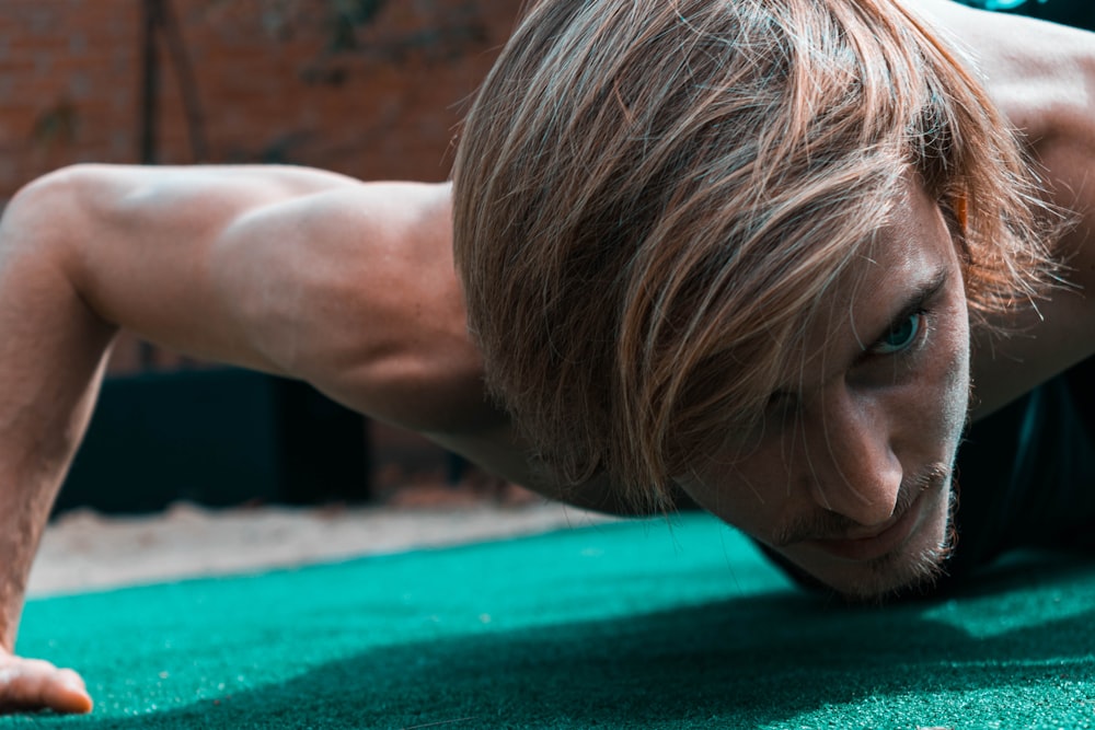 woman lying on green textile