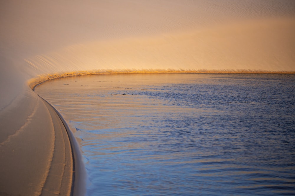 body of water during sunset