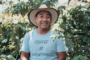 man in white crew neck t-shirt wearing brown straw hat