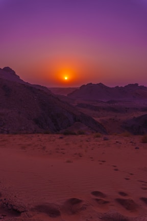 A picturesque sunset over the desert landscape of Saudi Arabia.