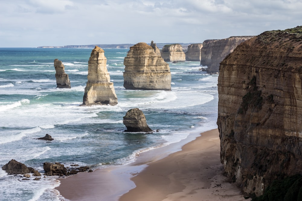 brown rock formation on seashore during daytime