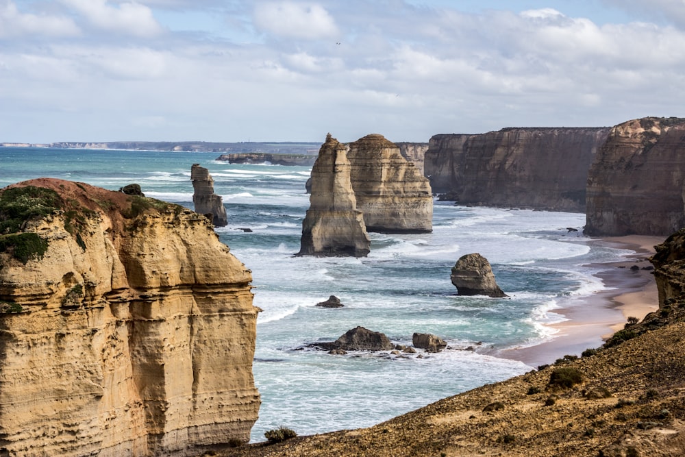 brown rock formation on sea shore during daytime