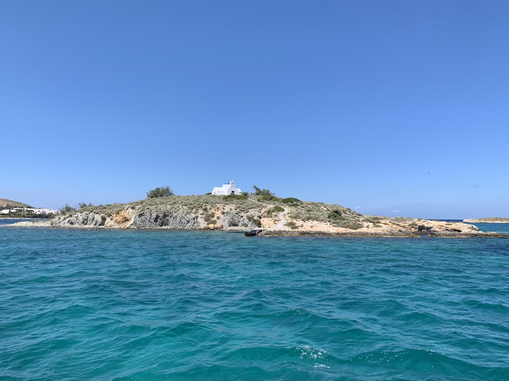 white and brown rock formation on sea under blue sky during daytime