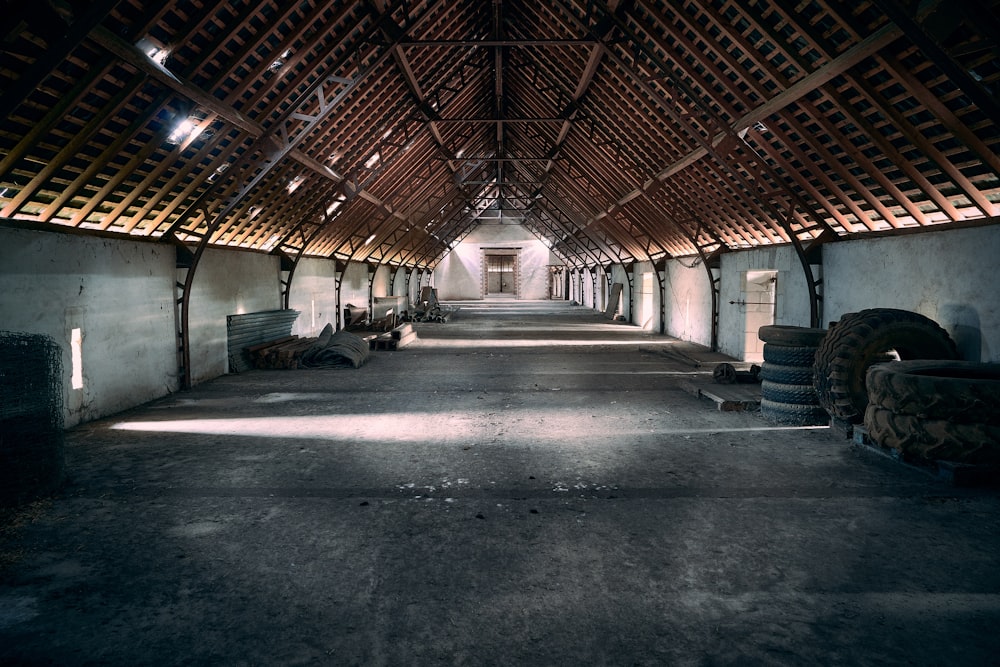 gray concrete pathway in between of brown wooden walls