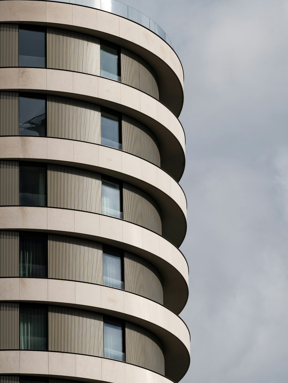 gray concrete building under white clouds during daytime