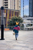 A smiling customer wearing hanjiara accessories while walking through a city street.