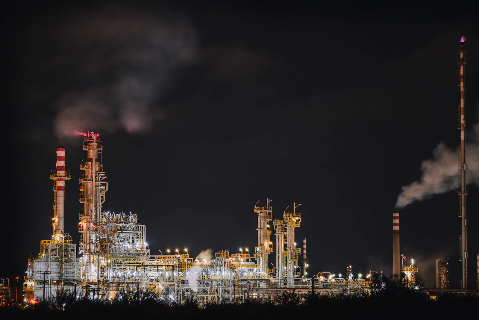 Illuminated process towers at night