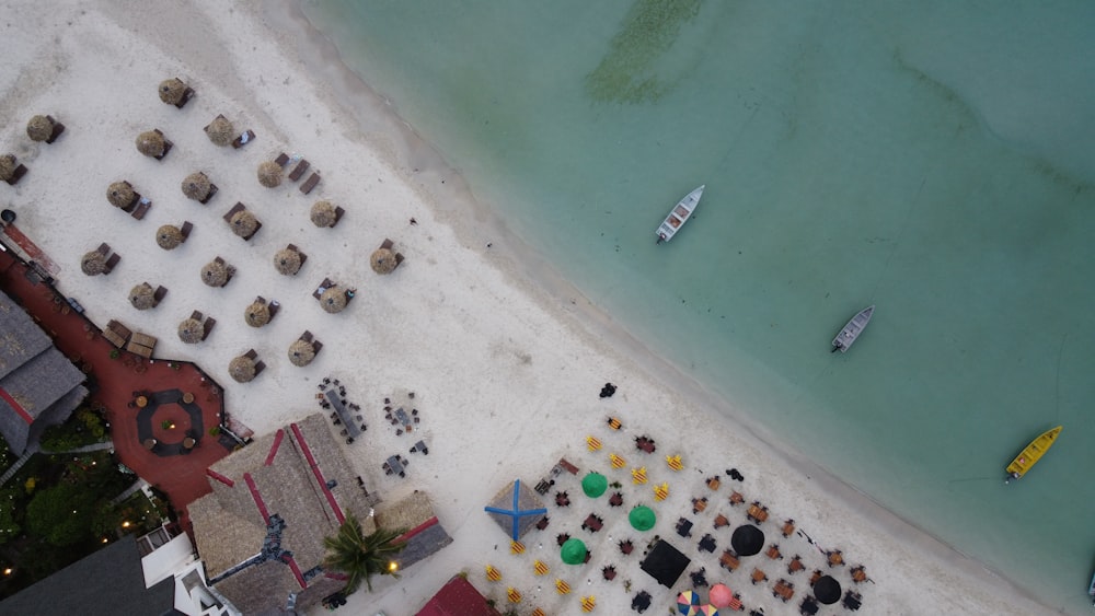an aerial view of a beach with a lot of tables and chairs