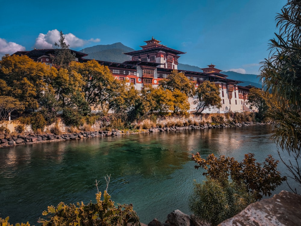 a large building sitting on top of a hill next to a river