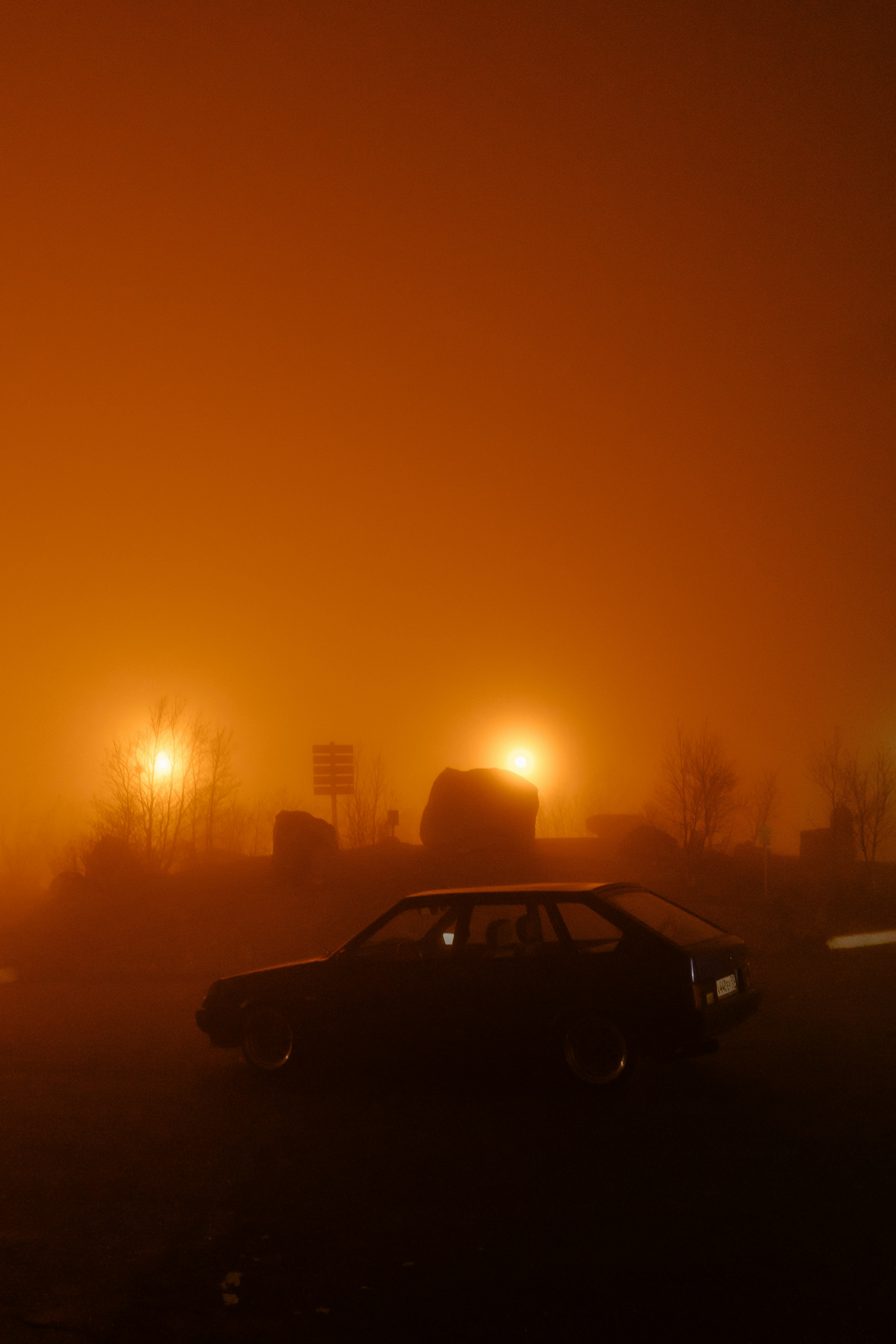 Black sedan on road during sunset