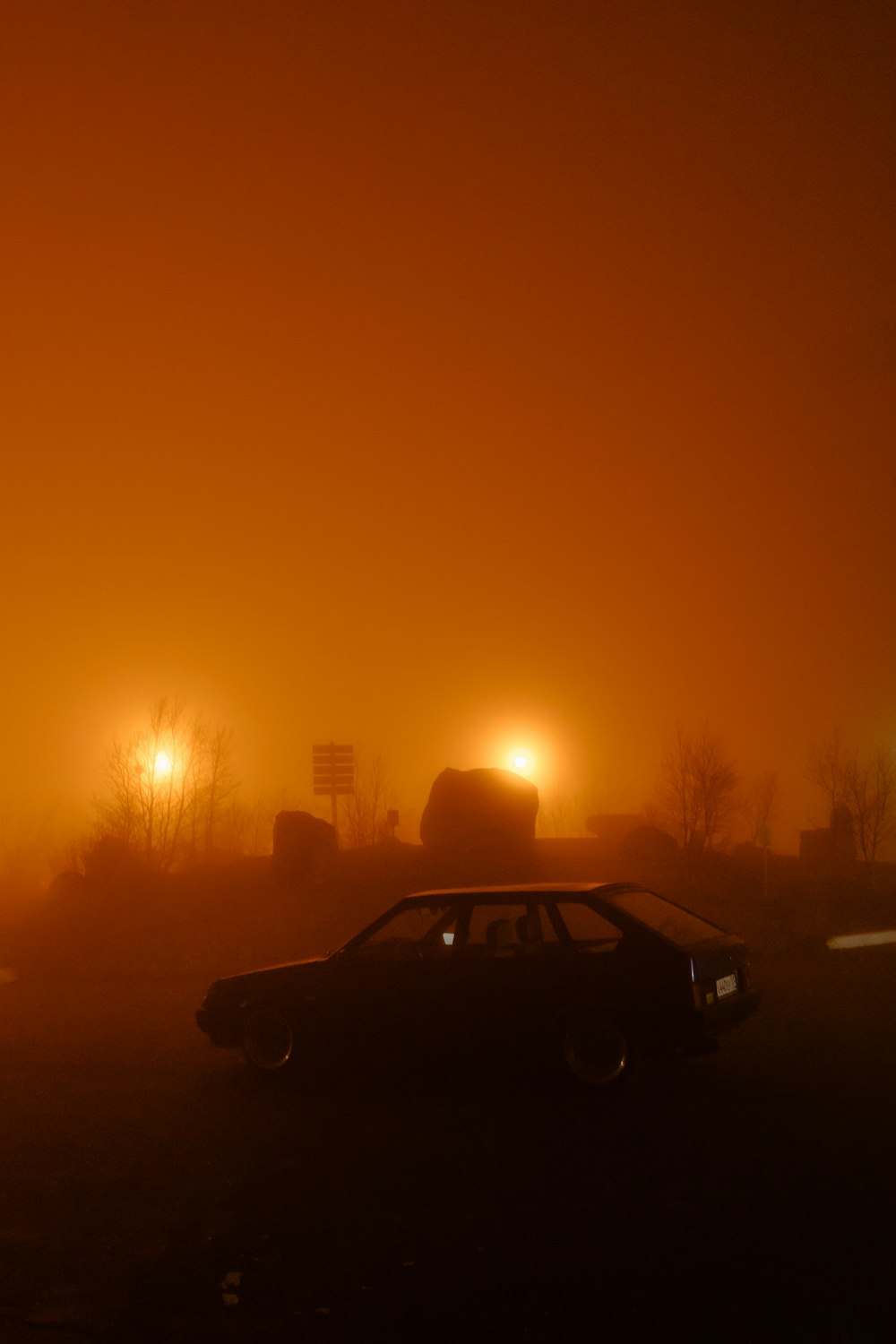 black sedan on road during sunset