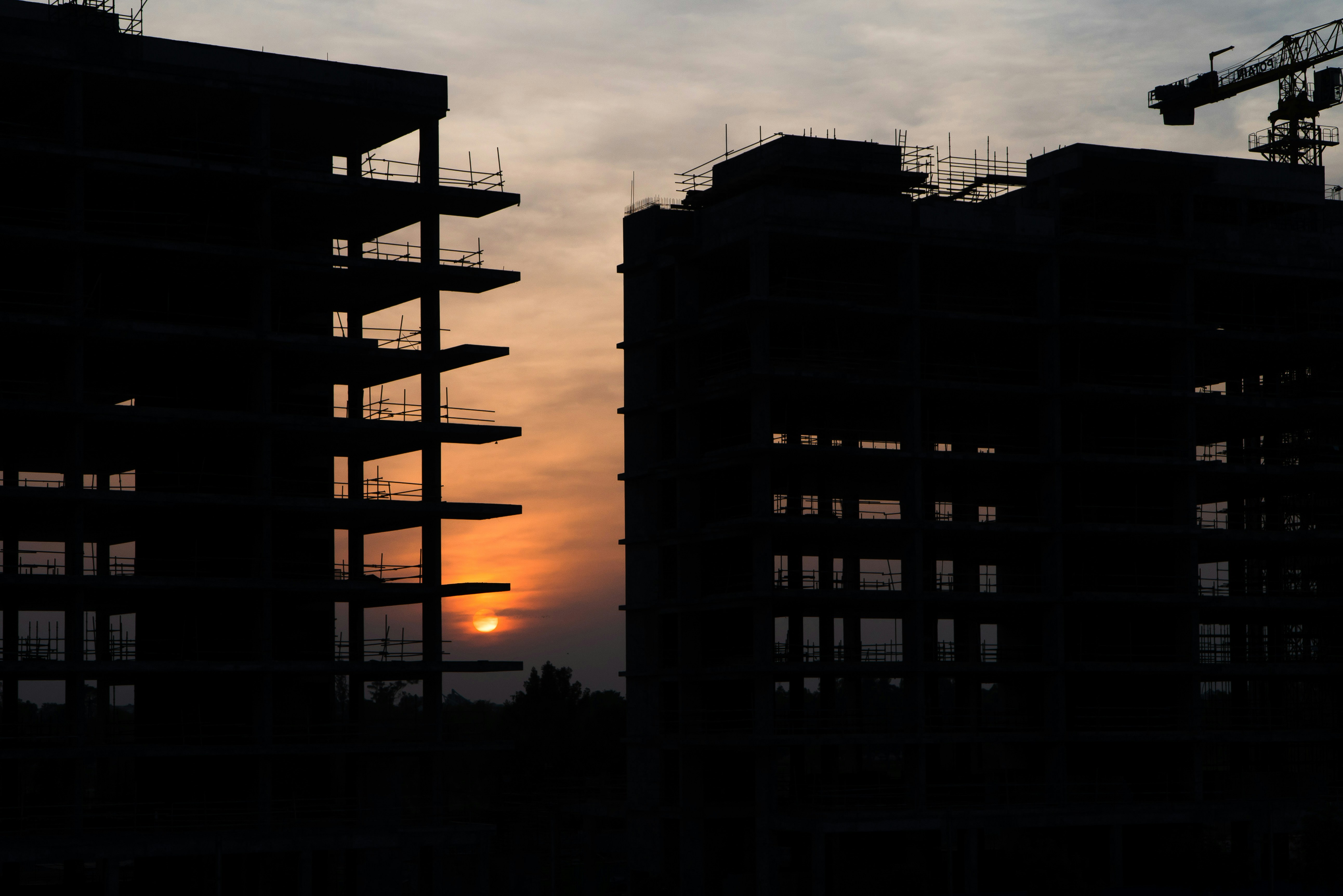 a couple of tall buildings under a cloudy sky