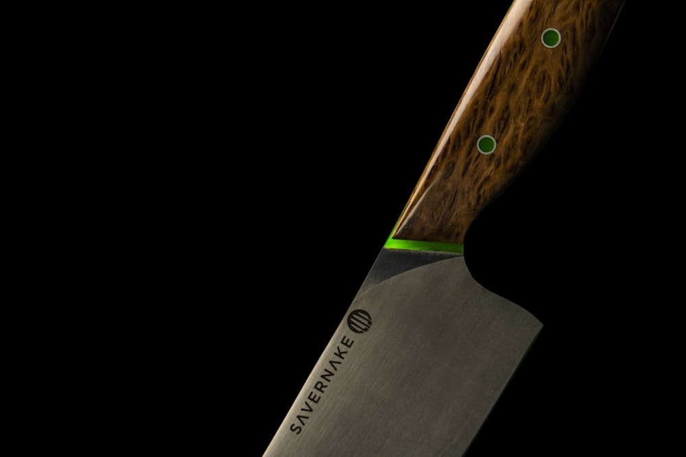 faca de madeira preta e marrom manuseada