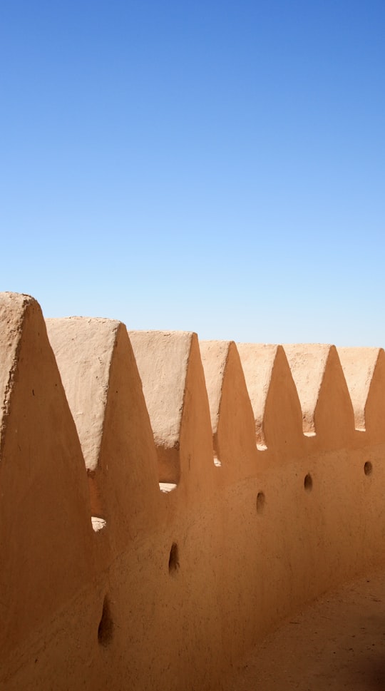 brown concrete wall under blue sky during daytime in Al Ain - Abu Dhabi - United Arab Emirates United Arab Emirates