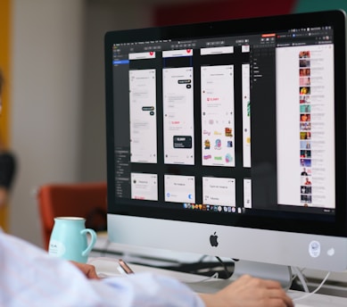 silver imac on brown wooden table