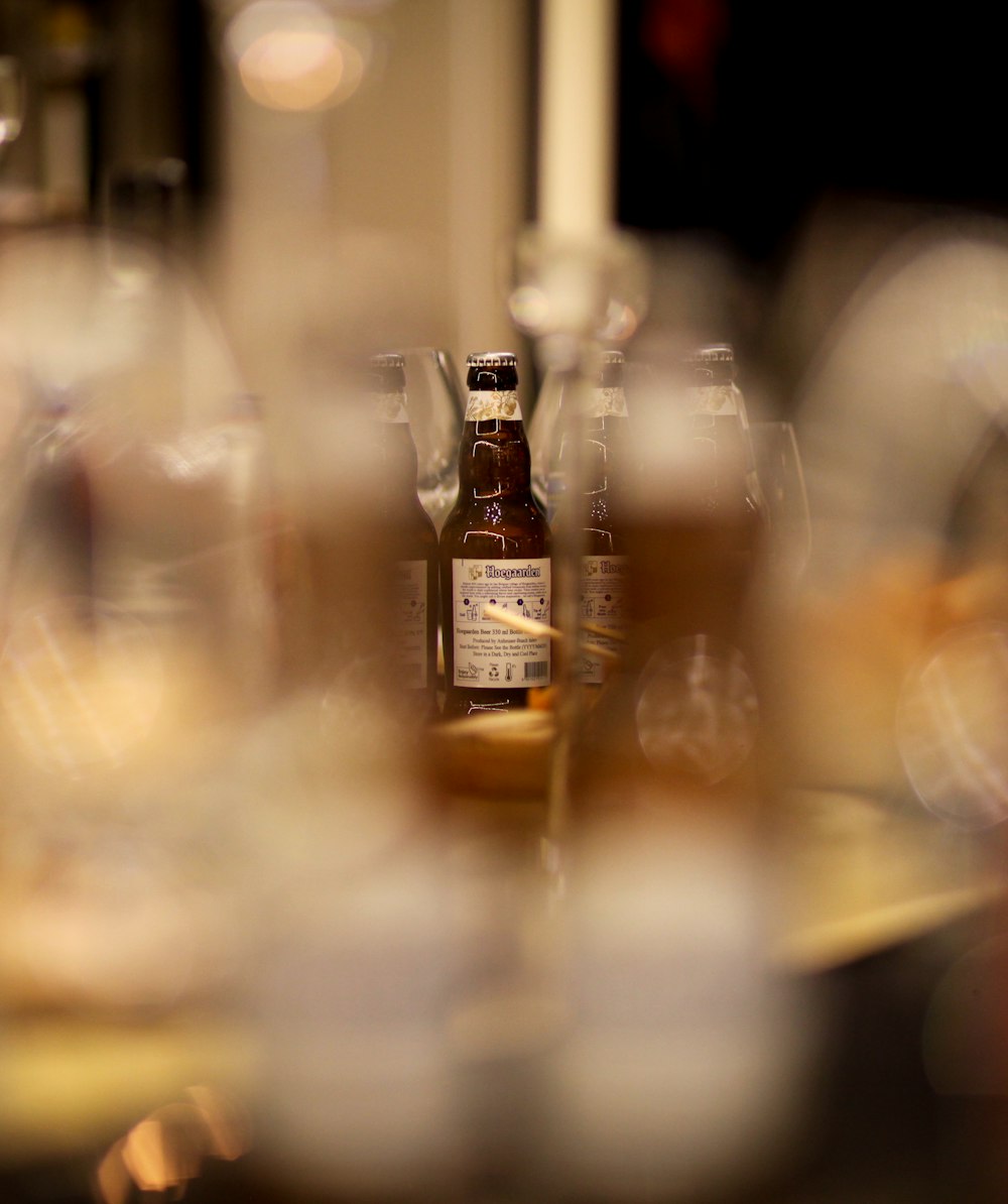 tilt shift lens photography of clear glass bottles