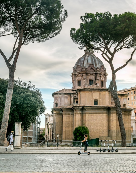 people walking near brown concrete building during daytime in Roman Forum Italy