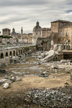 Close-up of ancient Roman ruins blending seamlessly with modern city life.