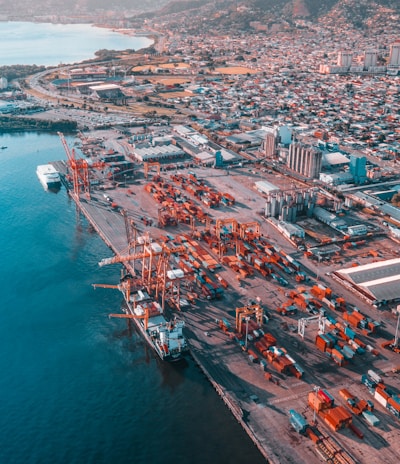 aerial view of city buildings near body of water during daytime