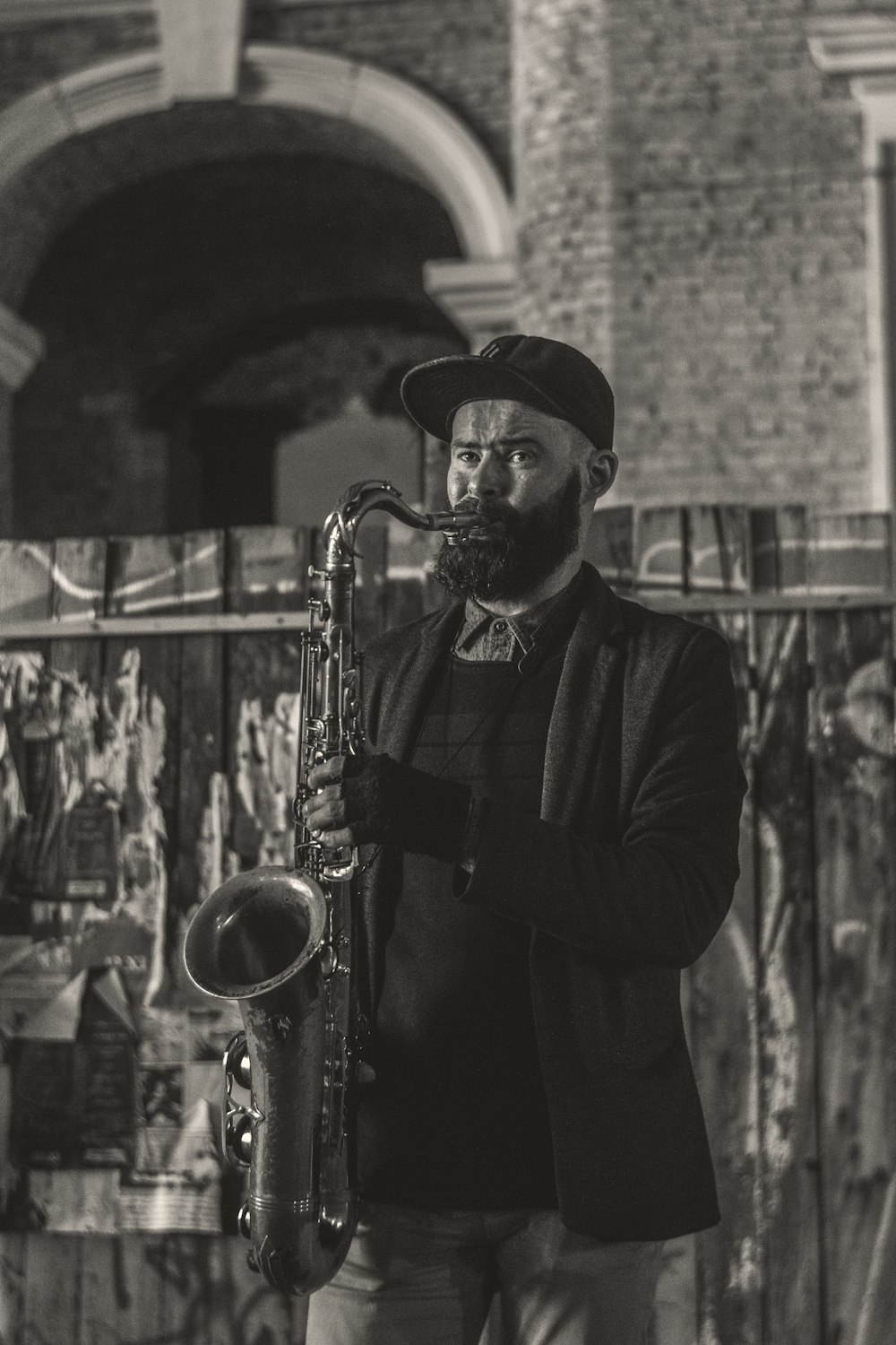 man in black jacket playing saxophone