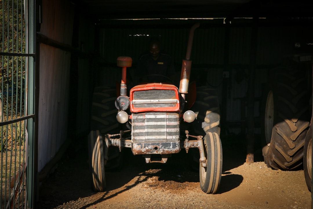 red and black tractor in garage