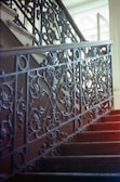 Elegant staircase with wrought iron railing and natural light