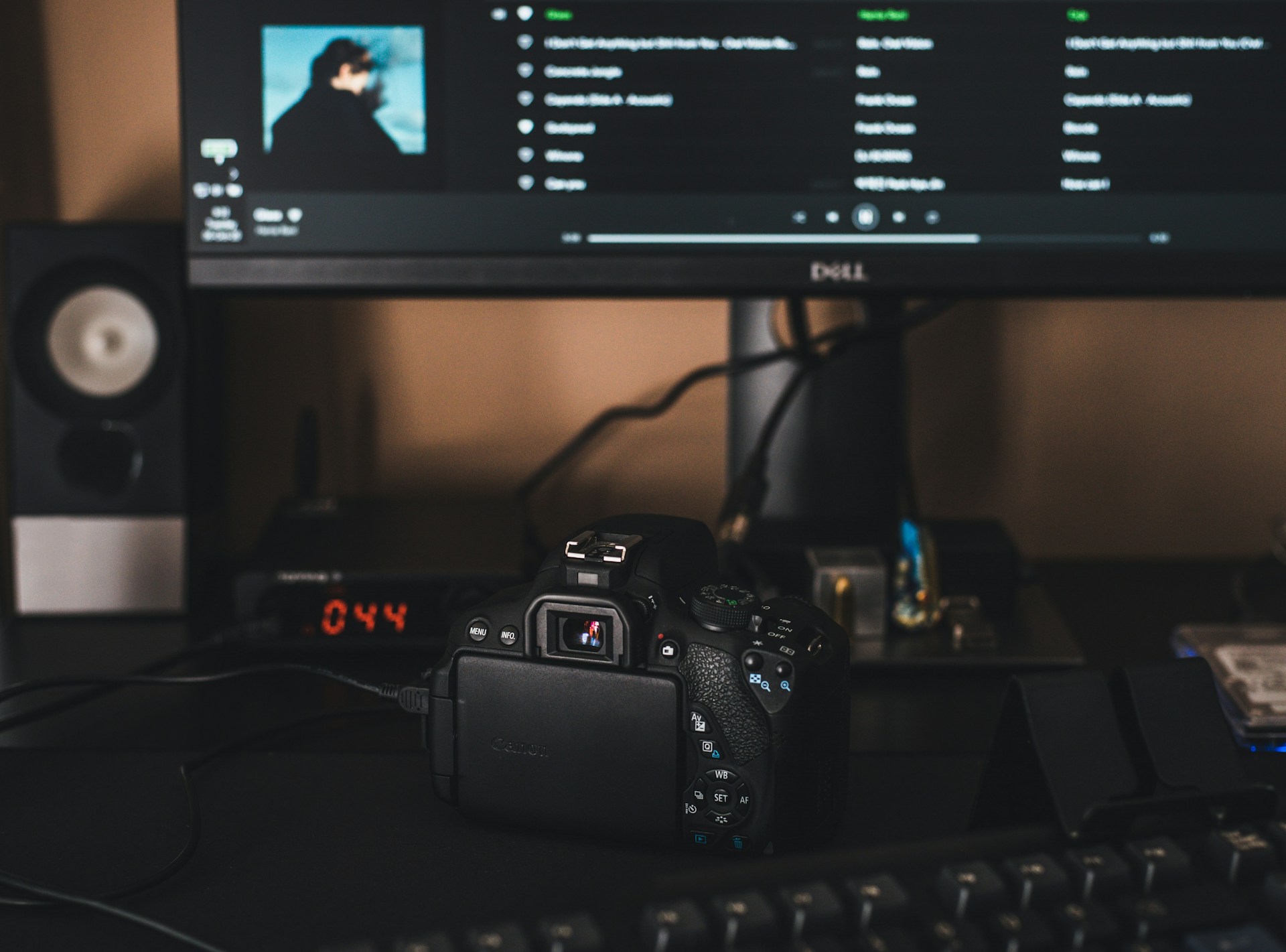 black canon dslr camera on black computer keyboard