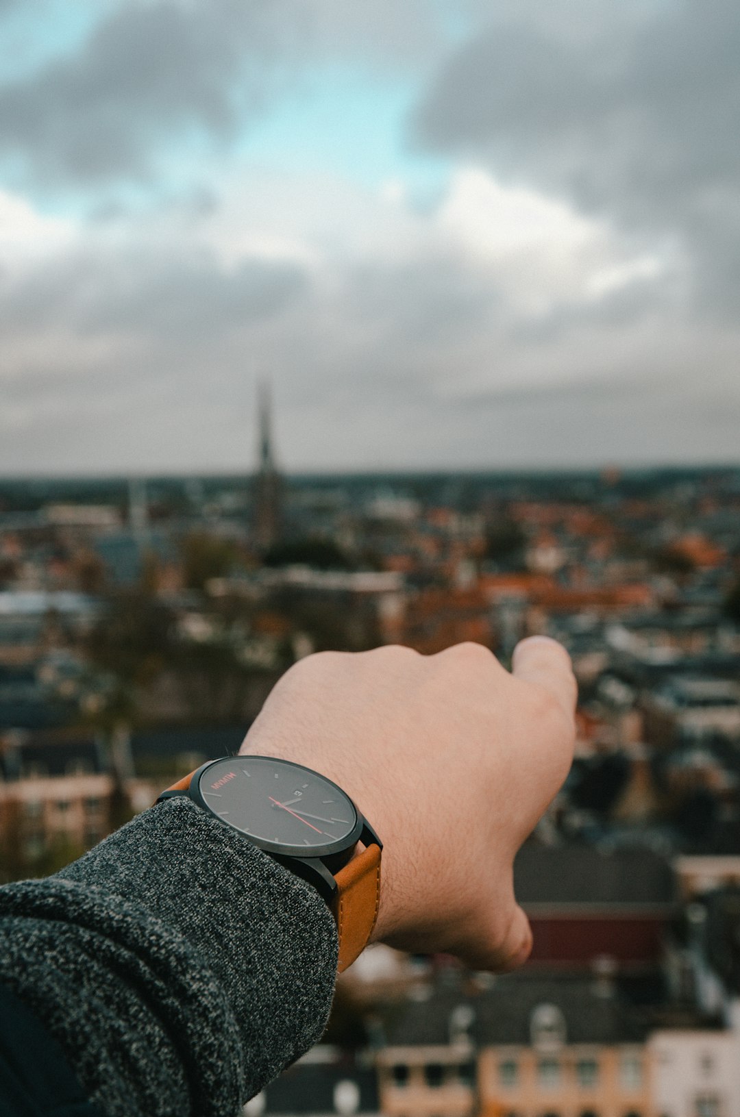 person wearing black and orange watch