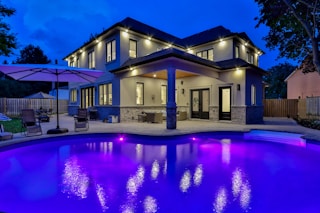 white concrete building near swimming pool during night time